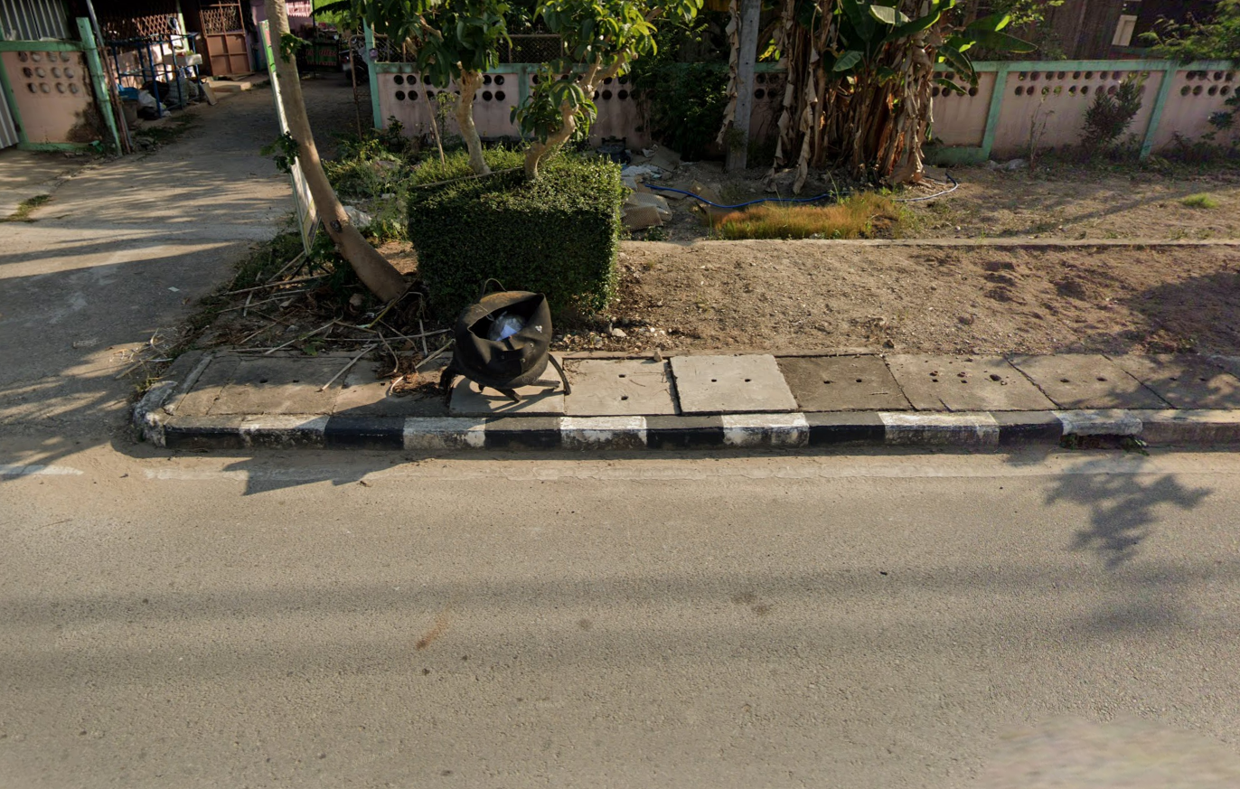 A black-and-white striped sidewalk in Thailand.